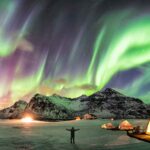 Man under Northern Lights and Aurora Borealis in top 10 countries to see the northern lights and aurora
